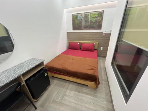 a small bed in a small room with a window at The rooftop villa 3 in Tây Ninh
