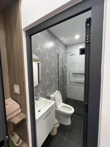 a bathroom with a toilet and a sink and a mirror at The rooftop villa 3 in Tây Ninh