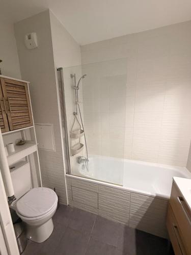 a bathroom with a toilet and a tub and a sink at DAKEY home - Disneyland Paris, Village Nature in Magny-le-Hongre