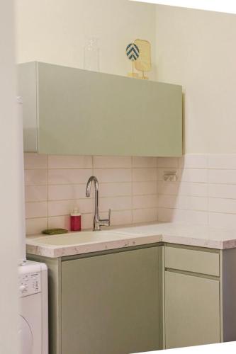 a kitchen with a sink and a dishwasher at City Centre Gem - Machne Yehuda in Jerusalem