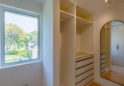 a dressing room with a window and a mirror at Villa Mansour in Abu Dhabi