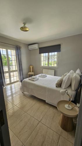 a bedroom with a large bed and a table at Vila Ventura Marina in Albufeira