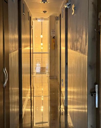 a hallway with a glass door with lights on it at Hotel Park Caribe in Medellín