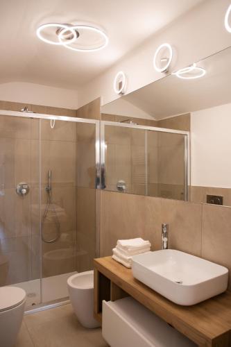 a bathroom with a sink and a shower at Villa Serena - Luminor Apartment in Tirrenia