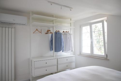 a bedroom with a bed and a dresser and a window at Villa Serena - Luminor Apartment in Tirrenia