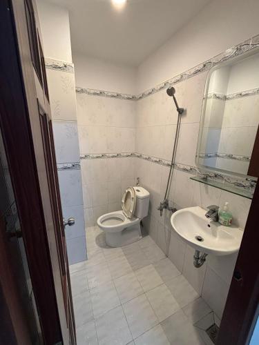 a bathroom with a toilet and a sink at Mai Guest House in Ho Chi Minh City