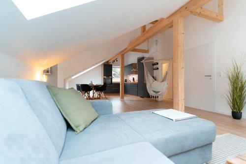 a living room with a blue couch and a table at SeeZeit Einruhr in Simmerath