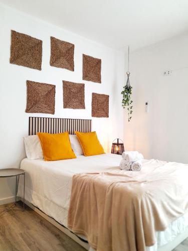 a bedroom with a large white bed with orange pillows at Easy4Stay in Portimão