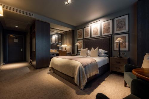 a hotel room with a bed and a desk at Dakota Manchester in Manchester