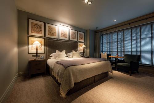 a bedroom with a bed and a desk and a chair at Dakota Manchester in Manchester