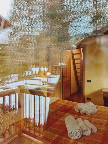 two towels are sitting on a bed in a room at Residence Les Myosotis in Champoluc