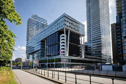a tall building in a city with tall buildings at Leonardo Hotel Den Haag Babylon in The Hague