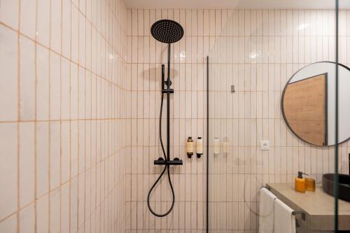 a shower with a shower head in a bathroom at Essence Villas - Bath & Sunset in Ribeira Grande