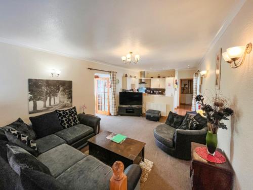 a living room with a couch and a table at Uk47549 - Carty Cottage in Newton Stewart