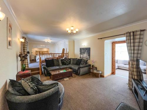 a living room with two couches and a tv at Uk47549 - Carty Cottage in Newton Stewart