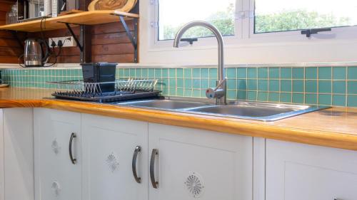 a kitchen counter with a sink and a stove at Traka Cottages in Sedgefield