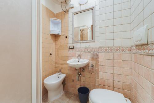 a bathroom with a toilet and a sink at Casa Athena - Goelba in Portoferraio