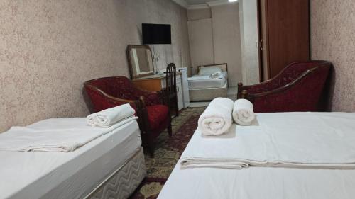 a hotel room with two beds and a bathroom at HOTEL Kenan in Doğubayazıt