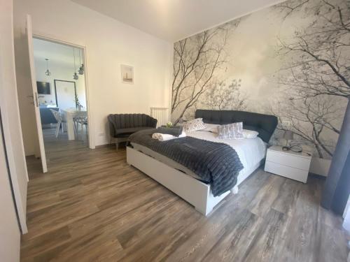 a bedroom with a bed and a living room at Lilly Garden Lago Lugano with private parking garden and air conditioning in Porlezza