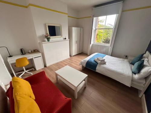 a small bedroom with a bed and a couch at 13 Frankfield Terrace, Summerhill South, Cork, T12 PY79 in Cork