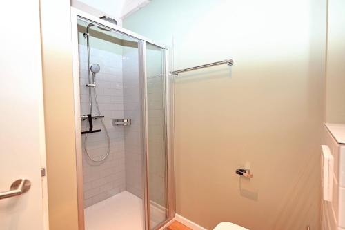 a shower with a glass door in a bathroom at Residenz R1 App 2 in Behrensdorf