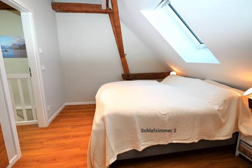 a bedroom with a bed with a skylight at Residenz R1 App 3 in Behrensdorf