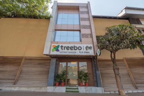 a tree in front of a building at Treebo Gateway Mansion in Mumbai