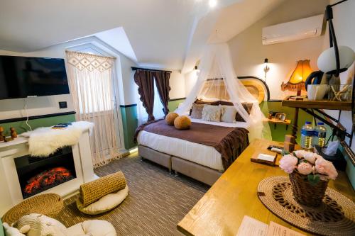 a bedroom with a bed and a fireplace at Hotel Zon in Serdivan