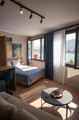 a hotel room with a bed and a couch at Gaia Apartments in Mytilene