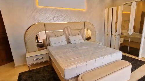 a bedroom with a bed with a white bed frame at Prestige Villa in Marrakesh