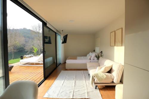 a bedroom with a bed and a bed and a sliding glass door at VILLA La Finca in Vieira do Minho