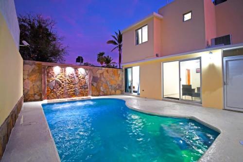 a swimming pool in front of a house at Poolside Retreat Lounge Parking Near Downtown in La Paz