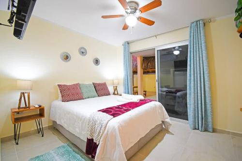 a bedroom with a bed and a ceiling fan at Poolside Retreat Lounge Parking Near Downtown in La Paz