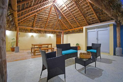 a patio with chairs and tables and a wooden roof at Poolside Retreat Lounge Parking Near Downtown in La Paz