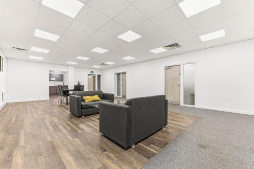 an office with two chairs and a couch in a room at Hayy Studios at Castleford in Castleford
