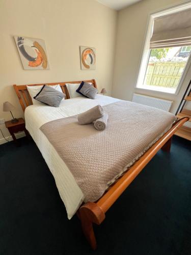 a large bed in a bedroom with a window at Miners cottage DH1 Bungalow Free Parking Longstay in Sheepscar