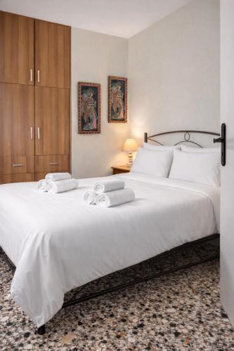 a bedroom with a large white bed with two towels at The Citrus Yard in Politika, 2 bedrooms apartment in Politika