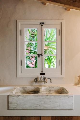 a kitchen sink with a window above it at Agroturismo Rafal Rubí in Alaior
