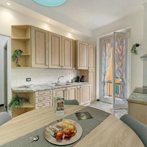 a kitchen with a table with a bowl of fruit on it at Janua Jungle House in Genoa