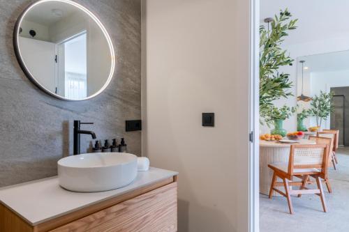 a bathroom with a sink and a mirror at Apartamentos Plaza España - Enjoy Sevilla in Seville