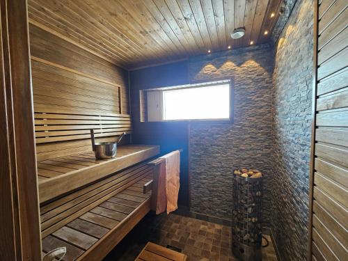 a sauna with wood paneling and a window at Villa Sevettijärvi in Sevettijärvi