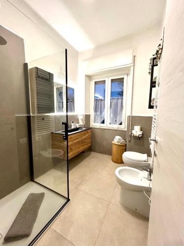 a bathroom with a shower and a toilet and a sink at Princess Home in Marina di Massa