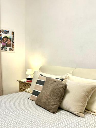 a bedroom with a bed with pillows on it at Princess Home in Marina di Massa