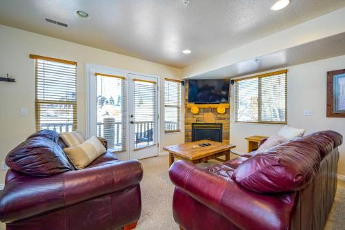 a living room with two leather couches and a fireplace at Bigfoots Alpine Retreat MH710By Powder Mtn Hot Tub in Eden