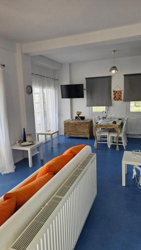 a living room with a couch and a table at White and Blue in Mesimvría