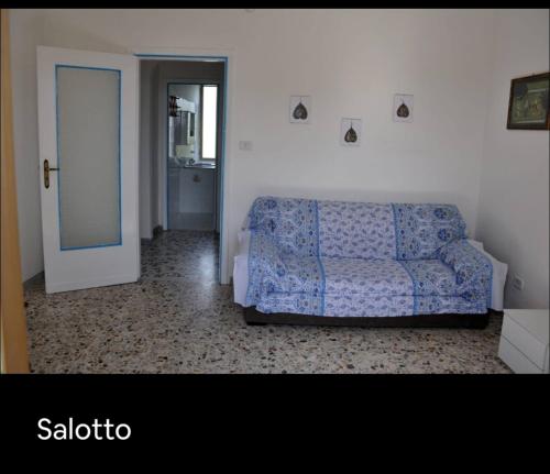 a living room with a blue couch and a door at Grande Procida in Procida