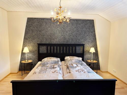 a bedroom with a large bed with two side tables at Ferienwohnung Mona Lisa in Malterdingen