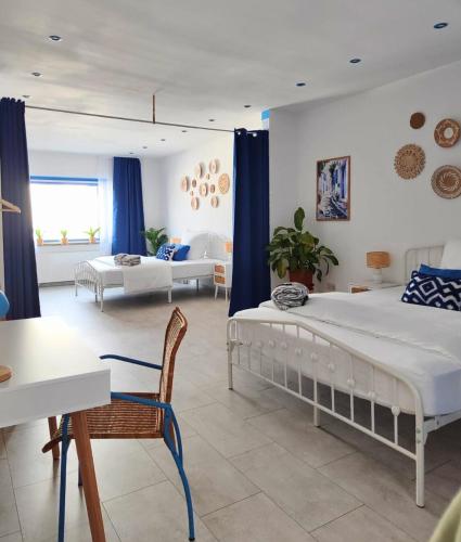 a bedroom with two beds and a living room at Weserblick Hafen-Villa-Bremen in Bremen