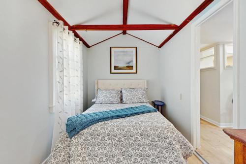 a bedroom with a bed in a room with white walls at 2 Mi to Dowses Beach! Couples Haven in Osterville in Osterville