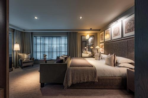 a bedroom with a large bed and a chair at Dakota Manchester in Manchester